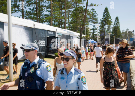 Two new south wales police officers male and female on patrol during  Hurley Australian Open of Surfing at Sydney's Iconic Manly Beach,Australia Stock Photo