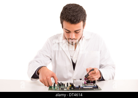 A computer engineer or technician, working on a computer motherboard Stock Photo