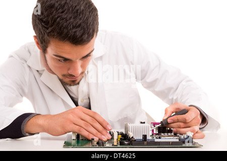 A computer engineer or technician, working on a computer motherboard Stock Photo