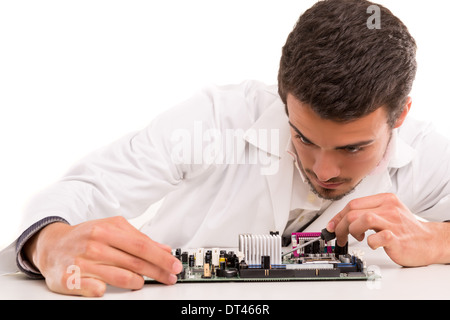 A computer engineer or technician, working on a computer motherboard Stock Photo