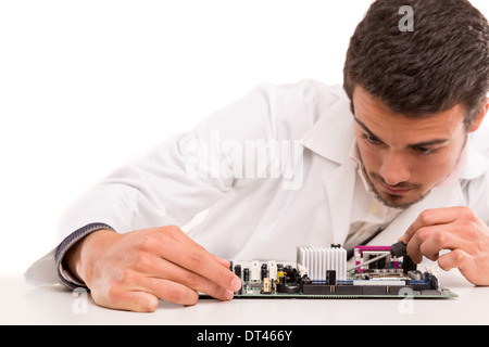 A computer engineer or technician, working on a computer motherboard Stock Photo