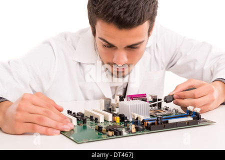 A computer engineer or technician, working on a computer motherboard Stock Photo