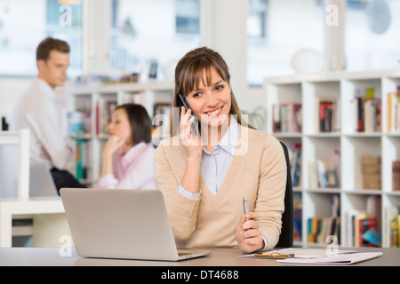 Female cheerful desk mobile phone computer Stock Photo