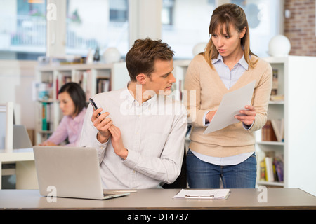 Female male business speak desk mobile phone Stock Photo