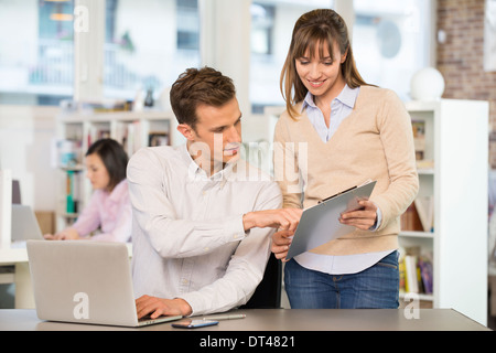 Businesswoman businessman cheerful desk talking Stock Photo