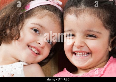 Happy twins smiling Stock Photo
