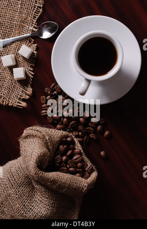 Coffee still life with cup, coffee beans in bag and sugar Stock Photo