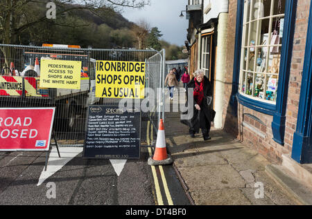 Shropshire, UK. 8th February 2014. The waterfront of the River Severn at Ironbridge, Shropshire, is closed to traffic due to imminent flooding. However, shops are open as usual for business behind the flood barriers. Credit:  John Bentley/Alamy Live News Stock Photo