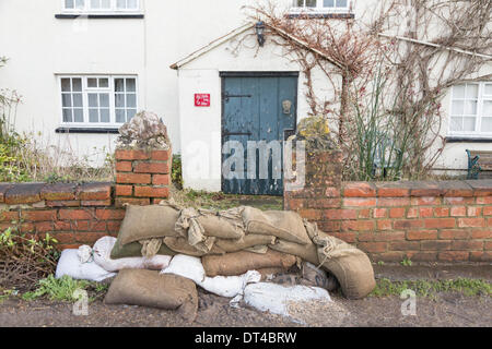 Flood defences at the village of Burrowbridge in Somerset on 8th February 2014. Due to high rainfall, the River Parrett has been unable to cope with the volume of water and has flooded nearby farmland leaving houses underwater.   Here sand bags and ballast try to prevent water entering a private residence. A severe flood alert remains and some occupants have been told to evacuate. Credit:  Nick Cable/Alamy Live News Stock Photo