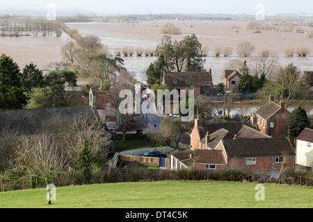 Borrowbridge, Somerset, UK. 8th February 2014. The village of Burrowbridge in Somerset on 8th February 2014 surrounded by floodwater as viewed from the top of Burrow Mump. Due to exceptionally high rainfall, the River Parrett has been unable to cope with the volume of water and has flooded nearby farmland and the main road the A361 to Taunton has been closed for seven weeks. A severe flood alert which means life may be at risk remains in place and many occupants have been told to evacuate. Credit:  Nick Cable/Alamy Live News