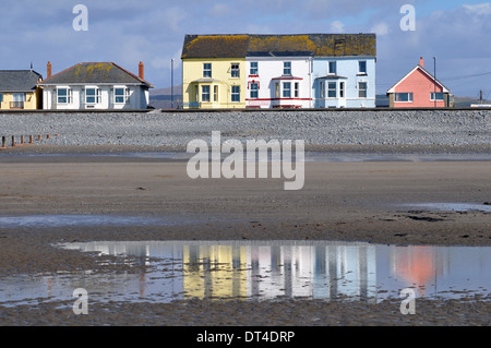 Seaside properties behind the sea-wall at Borth near Aberystwyth, Ceredigion, Wales, UK showing the beach at low tide. Stock Photo