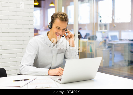 Cheerful male calling computer desk video conference, Skype Stock Photo