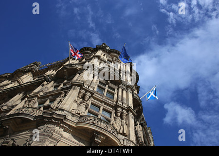 Jenners department store, on Princes Street, Edinburgh, Scotland, with blue sky and flags flying. Stock Photo