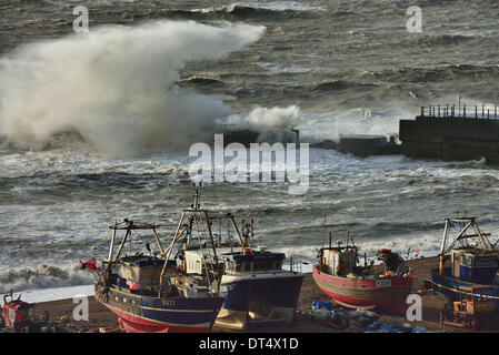 Waves breaking over the Harbour Arm, Stade beach, old town, Hastings, East Sussex, England, UK Stock Photo