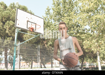 Young man playing basketball outdoor Stock Photo