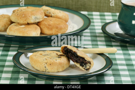 pastry cakes filled with mincemeat on a green table cloth Stock Photo