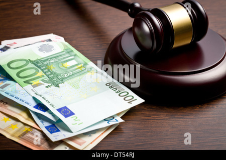 judge gavel with euro bills on wooden background Stock Photo