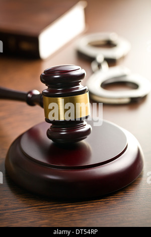 judge gavel with handcuffs on wooden table Stock Photo