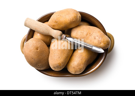 wooden peeler and potatoes on white background Stock Photo