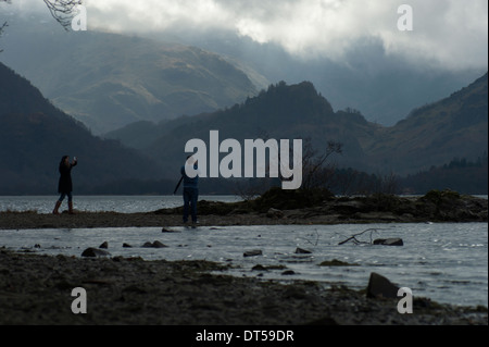 A couple taking pictures of each others and of the beautiful Borrowdale backgound in the Lake District. Stock Photo