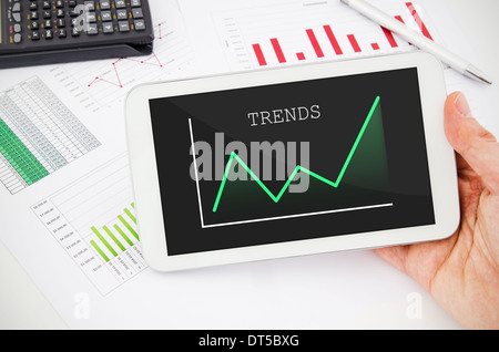 Businessman working with tablet pc. Report charts in background Stock Photo