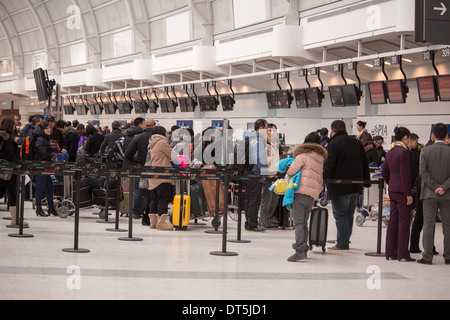 People lined up in a queue at the Air Transat desk in Terminal 3 at Pearson International Airport in Toronto Ontario Canada Stock Photo