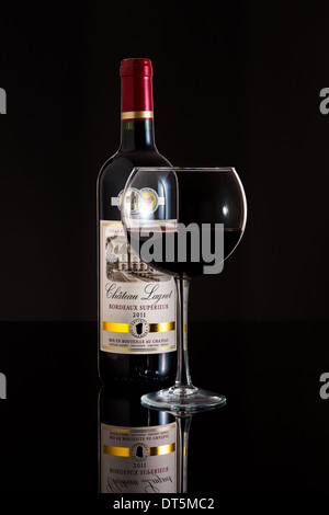 Glass and Bottle of 2011 Chateau Lagnet wine. Stock Photo