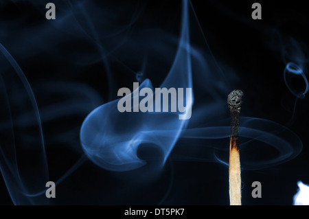 burned match stick on black Stock Photo