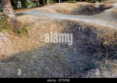 Mass graves that contained Khmer Rouge regime victims are displayed at Choeung Ek Killing Fields Museum in Phnom Penh, Cambodia. Stock Photo