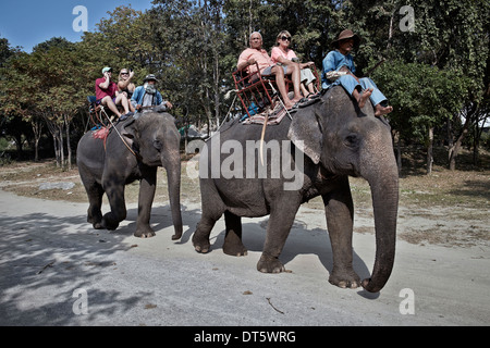 Tourists and mahout elephant trekking in Thailand tourism S. E. Asia
