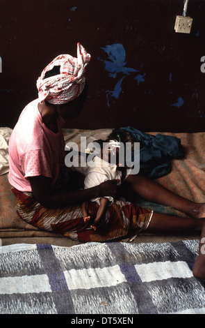 mother with a baby suffering from Malaria in Kenema in Sierra Leone Stock Photo