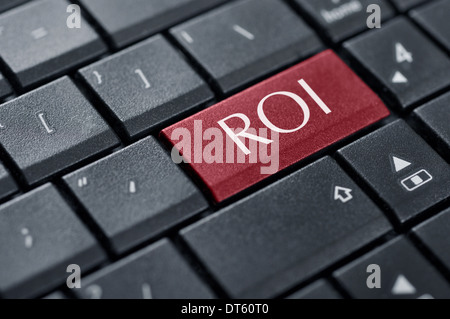 Return on Investment concept. Word ROI on button of computer keyboard. Stock Photo