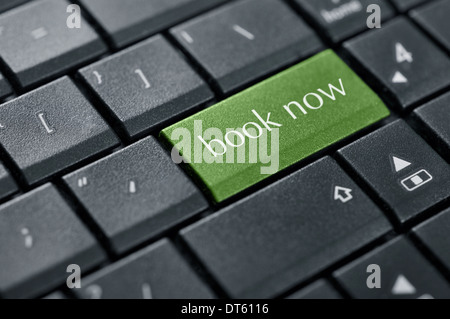 Book now green button on computer keyboard closeup Stock Photo
