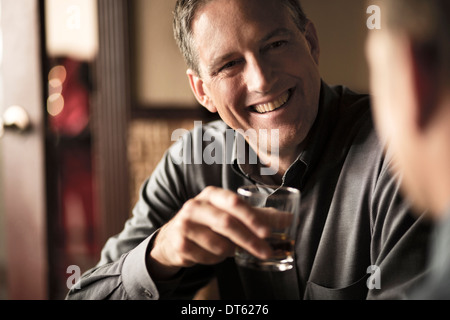 Business colleagues sharing a drink in wine bar Stock Photo
