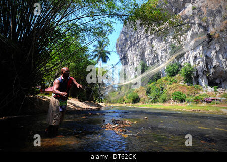 Kuala Lumpur, MYS, . 10th Feb, 2014. An ethic Malay man in the countryside fishing in river at a village north of Kuala Lumpur, Malaysia, Monday, February 10, 2014. Villagers in the countryside self sustain themselves by farming and hunting. © Joshua Paul/NurPhoto/ZUMAPRESS.com/Alamy Live News Stock Photo