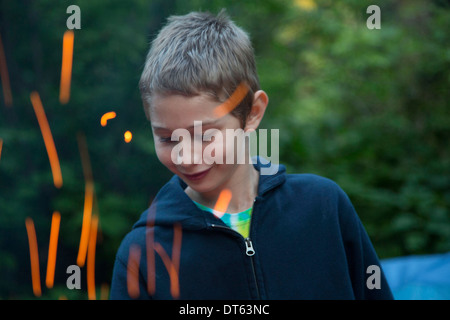 Boy with sparks from campfire Stock Photo