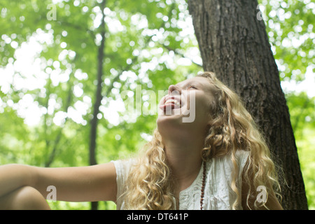 Teenage girl laughing in the woods Stock Photo