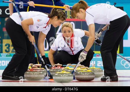 Sochi, Krasnodar Krai, Russia. 10th Feb, 2014. Great Britain's vice-skip Anna SLOAN (centre) looks on as teammates Vicki ADAMS (left) Claire HAMILTON (right) sweep during the Women's Curling round robin match between Great Britain and Sweden at the Ice Cube Curling Centre - XXII Olympic Winter Games © Action Plus Sports/Alamy Live News Credit:  Action Plus Sports/Alamy Live News Stock Photo