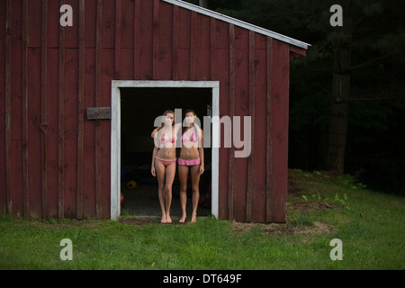 Friends posing by wood cabin Stock Photo