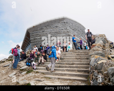 People sitting outside Mount Snowdon summit café Hafod Eryri on a busy summer weekend in Snowdonia National Park North Wales UK Stock Photo