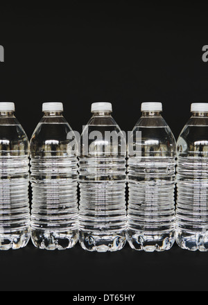 Row of clear, plastic water bottles filled with filtered water Stock Photo