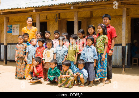 Bangladesh, Bandarban, Students and teachers stood outside a small primary school in a remote area of the Chitagong Hill tracts. Stock Photo