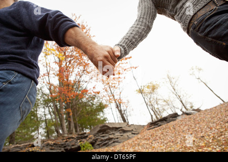 A couple, man and woman on a day out in autumn. Holding hands.