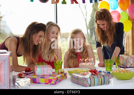 Teenage girl sharing birthday cake with friends Stock Photo
