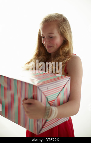 Portrait of teenage girl holding large birthday present Stock Photo
