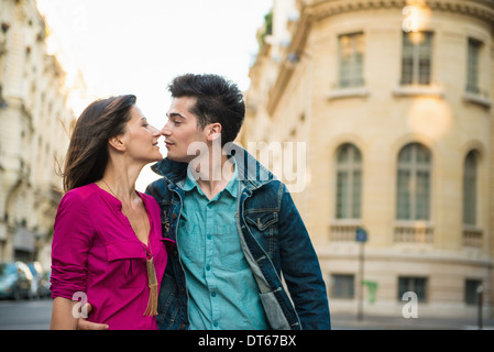 Young couple kissing on street, Paris, France