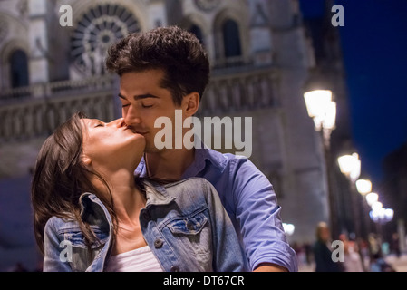 Young couple kissing at night, Paris, France Stock Photo