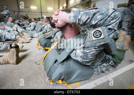 Grafenwoehr, Germany. 10th Feb, 2014. Paratroopers of the US Army wait to enter a helicopter at the training area in Grafenwoehr, Germany, 10 February 2014. About 350 soldiers jumped from about 330 meters above sea level from a military helicopter. The training prepares the 173rd Airborne Brigade for further operations. The unit has already been employed in the war zones in Iraq and Afghanistan. Photo: ARMIN WEIGEL/dpa/Alamy Live News Stock Photo