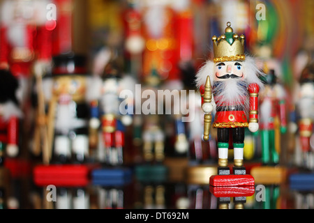 Little Santa stands next to an Armenian wooden Christmas tree toy