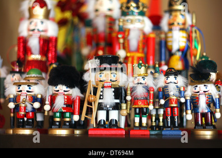 A row of various traditional Christmas nutcrackers, drummers and toy soldier figures, stand together as decoration Stock Photo